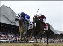  ?? ADAM COGLIANESE - THE ASSOCIATED PRESS ?? In a photo provided by the New York Racing Associatio­n, Essential Quality, left, with jockey Luis Saez, holds off Midnight Bourbon, with Ricardo Santana Jr., to win theTravers Stakes horse race Saturday, Aug. 28, 2021, at Saratoga Race Course in Saratoga Springs, N.Y.