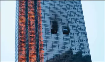  ?? ASSOCIATED PRESS ?? FIRE DAMAGE IS SEEN on a side of Trump Tower in New York on Saturday. The Fire Department says the blaze broke out on the 50th floor shortly before 6 p.m. Saturday.