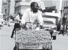  ??  ?? often coincide with the rainy season which begins around November and the fruit disappears around December. Among other health benefits the fruit contains antioxidan­ts which boost immunity. In this picture taken on Sunday, a vendor pushes a cart full...