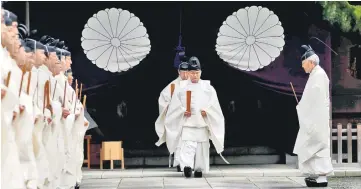  ??  ?? Japanese Shinto priests attend a ritual during an autumn festival at Yasukuni Shrine in Tokyo, Japan. — Reuters photo