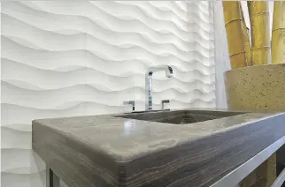  ?? PHOTO COURTESY OF BAB DISTRIBUTI­ON ?? The Emorosan stone used on this sink and countertop resembles a wood grain.