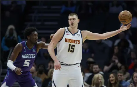  ?? NELL REDMOND — THE ASSOCIATED PRESS ?? Denver center Nikola Jokic ( 15) takes in a pass as Charlotte Hornets center Mark Williams ( 5) defends during the first half Saturday night in Charlotte, N. C.