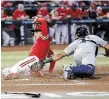  ?? CHRIS CODUTO GETTY IMAGES ?? Team Canada’s Freddie Freeman safely slides into home past Harry Ford of Team Great Britain during the first inning of the World Baseball Classic Pool C game at Chase Field on Sunday in Phoenix, Ariz.