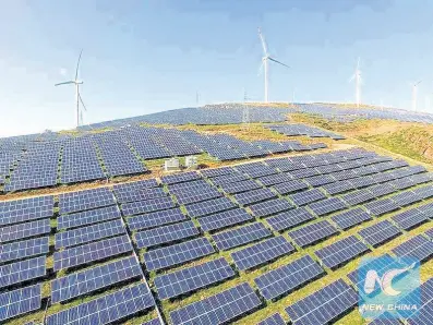  ?? PHOTO BY TIAN YIWEI / XINHUA ?? This photo, taken on May 15, 2016, shows a green energy base which provides both wind and solar power in Yiyang County, central China’s Henan province.