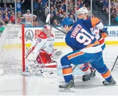  ?? BRUCE BENNETT/GETTY IMAGES ?? Islanders captain John Tavares shoots the puck off and past Capitals goaltender Braden Holtby for the winning goal of Game 3 at Nassau Coliseum.