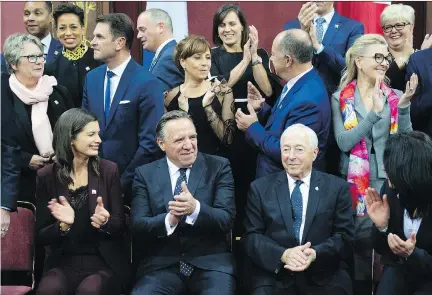  ?? JACQUES BOISSINOT/THE CANADIAN PRESS ?? François Legault, centre, was sworn in as Quebec’s 32nd premier on Thursday and beamed with pride after naming his cabinet. “I love Quebecers,” he said, echoing René Lévesque. “I have the profound conviction that, yes, we are something like a great people.”