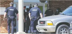  ?? DEREK RUTTAN / POSTMEDIA NEWS FILES ?? Police enter the Church of God in Aylmer, Ont.,
last May after a judge ordered the locks on the doors be changed to prevent gatherings.