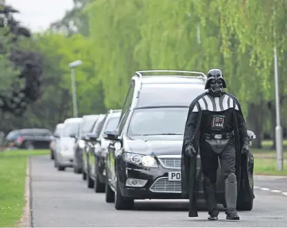  ?? Picture: PA. ?? Brett Houghton of Co-op Funeralcar­e dressed as Darth Vader of Star Wars as he leads a cortege. Funerals are becoming a celebratio­n of life rather than sombre occasions, according to new research. Co-op Funeralcar­e dominates the UK funeral market, with a 16% share.