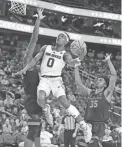  ?? STEPHEN R. SYLVANIE/USA TODAY SPORTS ?? ASU guard DJ Horne shoots between Oregon State’s Rodrigue Andela and Glenn Taylor Jr. (35) during the first half at T-Mobile Arena on Wednesday in Las Vegas.