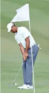  ??  ?? Tiger Woods chips to the first green during round two of the Hero World Challenge - AFP