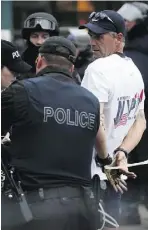  ?? Tim Fraser for National Post ?? A man is arrested after G20 protesters and pedestrian­s alike
were surrounded by police at the corner of Spadina and Queen streets in Toronto on June 27, 2010.