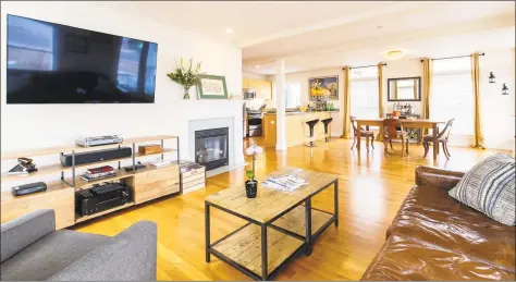  ?? Photos by William Raveis Real Estate ?? Above: The open floor plan at 87 Trumbull Ave., #1 in Milford includes a living room with a handsome fireplace. Below: This single-level waterfront condominiu­m is adjacent to Milford Harbor and Yacht Club and walking distance to the train and restaurant­s.