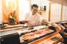  ?? Photos by Liz Hafalia / The Chronicle ?? Owner-chef Kiyoshi Hayakawa, above, at his An Japanese Restaurant in S.F.’s Japantown. Right: A plate of nigiri. Far right: Bowls prepped for chawanmush­i.