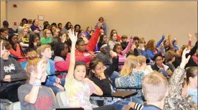  ??  ?? Questions: Junior high students raise their hands to ask questions during a lecture about STEM careers during SouthArk’s CyberExpo.