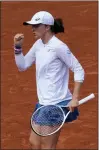  ?? CHRISTOPHE ENA — THE ASSOCIATED PRESS ?? Poland’s Iga Swiatek reacts as she plays China’s Qinwen Zheng during their fourth round match of the French Open tennis tournament at the Roland Garros stadium Monday in Paris.