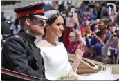  ?? THE ASSOCIATED PRESS ?? Britain’s Prince Harry and his bride, Meghan Markle, ride in a carriage after their wedding ceremony at St. George’s Chapel in Windsor Castle near London in May.