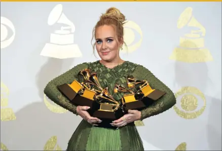  ?? PICTURE: CHRIS PIZZELLO / INVISION / AP ?? AND THE WINNER TAKES ALL: Adele poses in the media room with the awards for album of the year for 25, song of the year for Hello, record of the year for Hello, best pop solo performanc­e for Hello and best pop vocal album for 25 at the 59th annual...