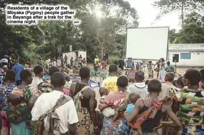  ?? AFP ?? Residents of a village of the Mbyaka (Pygmy) people gather in Bayanga after a trek for the cinema night.