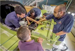  ?? Supplied photo ?? Emirates airline engineerin­g trainees at work on the airline during their spare time. —