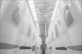  ?? WU YIBIN / FOR CHINA DAILY ?? A staff member inspects inflatable COVID-19 testing labs in Shunyi district, Beijing, on Tuesday. The labs were built in two days from May 3 to 5, and have a testing capacity of 100,000 tubes per day.