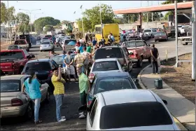  ?? AP/RODRIGO ABD ?? People wait in sometimes mile-long lines to get gasoline last week in Cabimas, Venezuela.