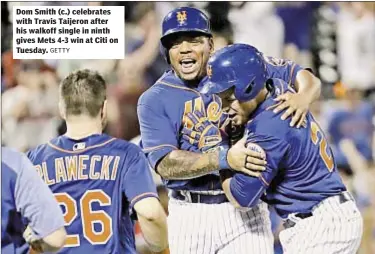  ?? GETTY ?? Dom Smith (c.) celebrates with Travis Taijeron after his walkoff single in ninth gives Mets 4-3 win at Citi on Tuesday.