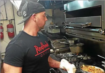  ?? TAWANA ROBERTS — THE NEWS-HERALD ?? Chef Matt Layden makes Redhawk Grille’s best-selling New Orleans Jambalaya on Feb. 23.