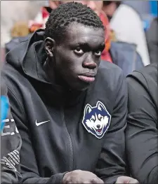  ?? JESSICA HILL/AP PHOTO ?? Akok Akok watches Sunday’s game between UConn and Arizona at the XL Center in Hartford. Akok announced on Saturday that he has committed to UConn.