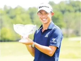  ?? AP PHOTO/DARRON CUMMINGS ?? Collin Morikawa holds his trophy after winning the Workday Charity Open on Sunday in Dublin, Ohio.