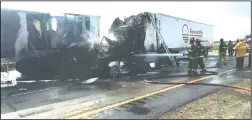  ?? COURTESY OF THE CALIFORNIA HIGHWAY PATROL STOCKTON OFFICE ?? Firefighte­rs work to extinguish the flames caused by a seven-vehicle collision on Interstate 5 north of Eight Mile Road that killed two people on Thursday morning.