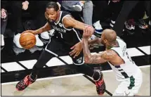  ??  ?? Brooklyn Nets’ Kevin Durant, (left), drives past Milwaukee Bucks’ P.J. Tucker during the first half of Game 7 of a second-round NBA basketball playoff series in New York. (AP)