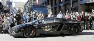  ??  ?? Not only does the kid have a batsuit, he has a cool ride to go with it, driver included, of course. – MCT