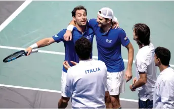  ?? — AFP photo ?? (Facing camera, from left) Bolelli and Fognini celebrate after winning at the end of the Davis Cup men’s double quarterfin­al match against the US in Malaga.