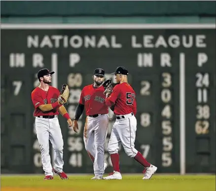  ?? Omar Rawlings Getty Images/TNS ?? OUTFIELDER­S Andrew Benintendi, Jackie Bradley Jr. and Mookie Betts, from left, are important members of a potent Boston Red Sox team that is finding its stride after a slow start in its quest to repeat as World Series champion.