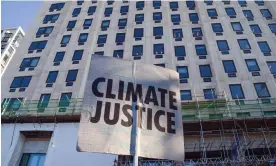  ?? Photograph: Vuk Valcic/Sopa Images/Rex/Shuttersto­ck ?? A placard outside Shell’s headquarte­rs in London. Directors of the company are being sued in the first case of its kind.