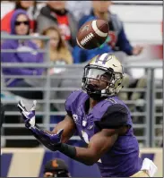  ?? AP PHOTO ?? Washington’s John Ross reaches for a 38-yard touchdown pass against Rutgers in the first half.