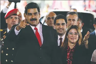  ?? AP/RICARDO MAZALAN ?? Venezuelan President Nicolas Maduro and first lady Cilia Flores acknowledg­e supporters Tuesday at a Caracas ceremony after the U.S. denounced his election Sunday as a “sham.”