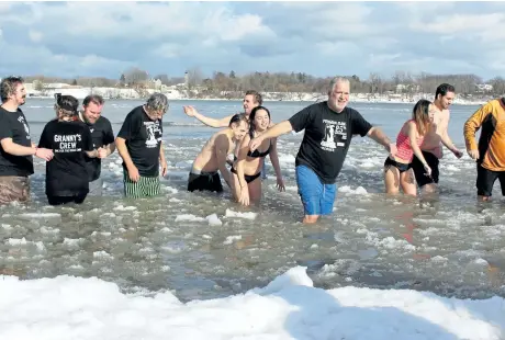  ?? PHOTOS BY ALISON LANGLEY/NIAGARA FALLS REVIEW ?? About 20 hearty souls take part in the annual Penguin Club Dip in Niagara-on-the-Lake, Tuesday.