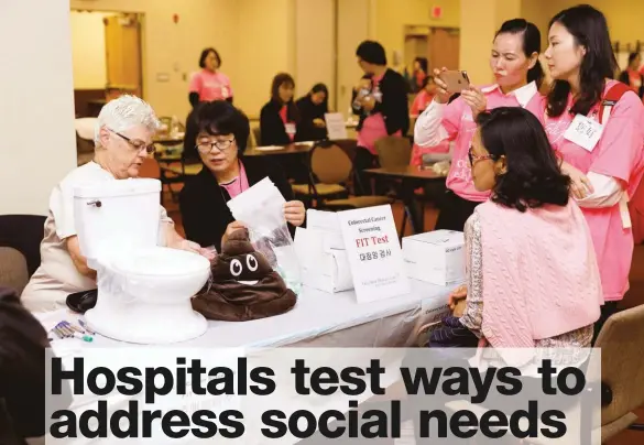  ??  ?? Clinicians at Holy Name Medical Center in Teaneck, N.J., distribute home colorectal cancer screening kits at the annual Asian Health Services Health Fair last September.