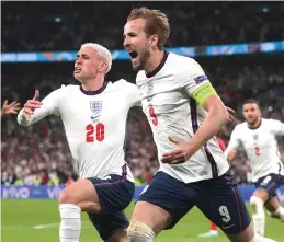  ?? (Reuters) ?? ENGLAND FORWARD Harry Kane (front) celebrates with his teammates after he scored the game-winning goal in extra time of his side’s 2-1 victory over Denmark late Wednesday night at Wembley Stadium to earn a berth in Sunday’s Euro 2020 final.