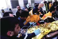  ?? IHA via AP ?? ■ Rescue workers pull out Samir Muhammed Accar, a Syrian migrant, from a collapsed building in Antakya, Turkey, on Saturday. On the 13th day of rescue operations, three people, including a child, were extracted from under an apartment building in Antakya.