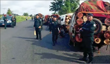  ?? SUPPLIED ?? Officials inspect and seize illegal firewood after a bust yesterday in Kratie province.