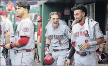  ?? ASSOCIATED PRESS] [MARK TENALLY/THE ?? Scooter Gennett of the Reds, center, celebrates his solo home run during the first inning Friday night.