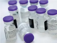  ?? Getty IMaGes FIle ?? LIFESAVING VACCINES: Vials of undiluted Pfizer COVID19 vaccine are prepared to administer to staff and residents at the Goodwin House Bailey’s Crossroads, a senior living community in Falls Church, Va., in December.