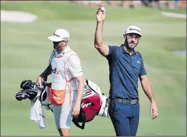  ??  ?? Dustin Johnson acknowledg­es the crowd after an eagle on the 18th hole during the final round of the St. Jude Classic yesterday in Memphis, Tenn. The Associated Press