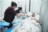  ?? PHOTO: REUTERS ?? A patient receives medical treatment in a ward for Azeri civilians wounded in the NagornoKar­abakh conflict at a hospital in the city of Yevlakh, Azerbaijan, yesterday.