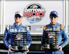 ?? ASSOCIATED PRESS ?? DALE EARNHARDT JR. (LEFT) AND CHASE ELLIOTT display their front row trophies after qualifying for the top two positions in the NASCAR Daytona 500 auto race Sunday at Daytona Internatio­nal Speedway in Daytona Beach, Fla.