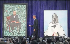  ?? MARK WILSON/GETTY IMAGES ?? Former President Barack Obama stands with his and former first lady Michelle Obama’s portraits in February 2018 at the Smithsonia­n's National Portrait Gallery in Washington, D.C.