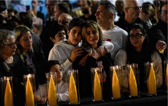  ?? ARIEL SCHALIT/ASSOCIATED PRESS ?? Relatives and friends of hostages held by Hamas called for their release during a Hanukkah event in Tel Aviv on Thursday.