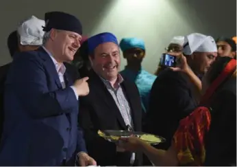  ?? SEAN KILPATRICK/THE CANADIAN PRESS ?? Conservati­ve Leader Stephen Harper and candidate Jason Kenney were all smiles at a campaign stop in Scarboroug­h on Wednesday. But a new poll has the Tories in third place behind the NDP and the Liberals.